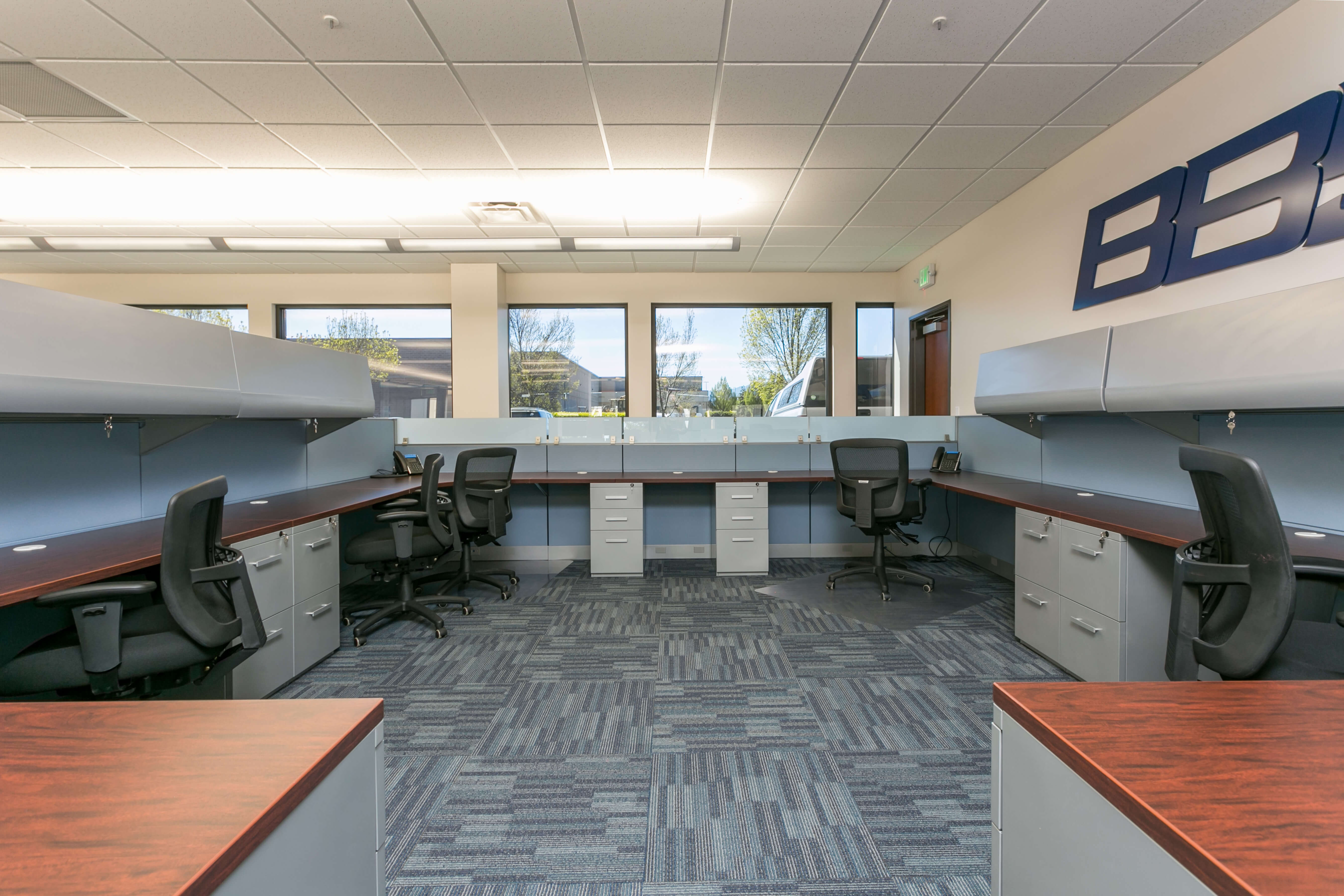 office space with tenant improvements: permanent desks installed in rows with partitions