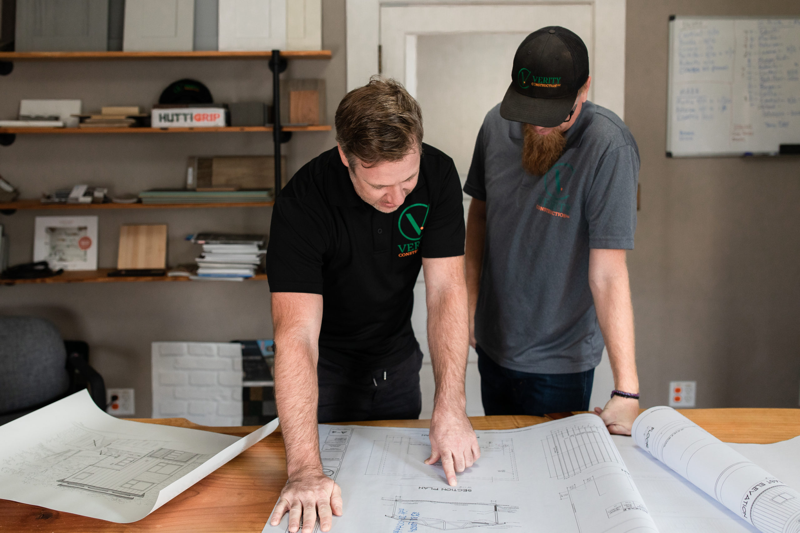 Licensed general contractors of Verity Construction assess blueprints for custom home build in Medford, OR