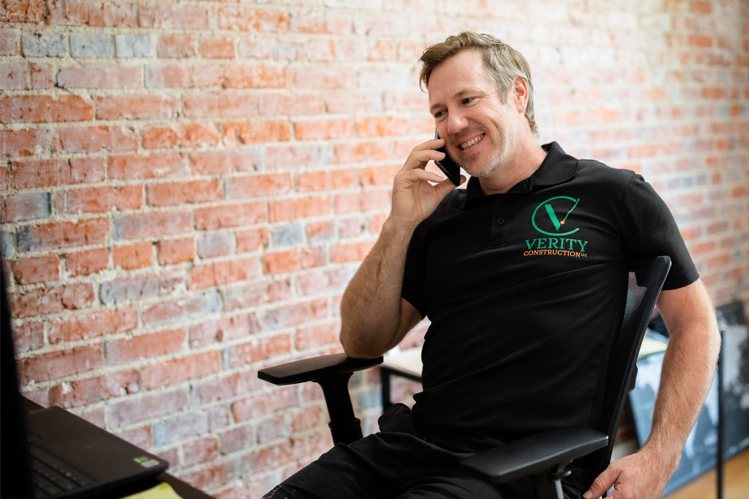 Tim Plankenhorn, founder of Verity Construction, general contractors in Medford, Oregon, taking a phone call in his office